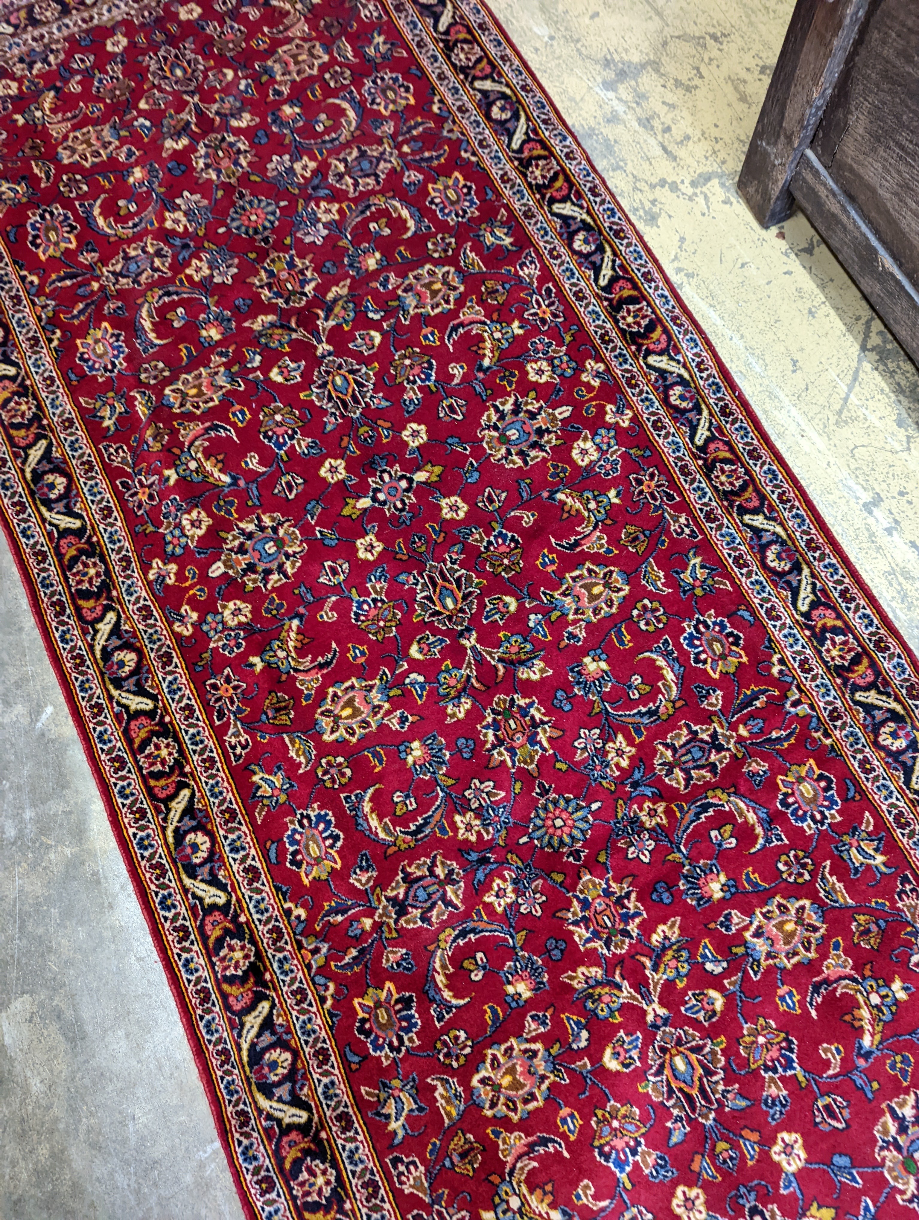 A Kashan red ground runner, 340 x 101cm